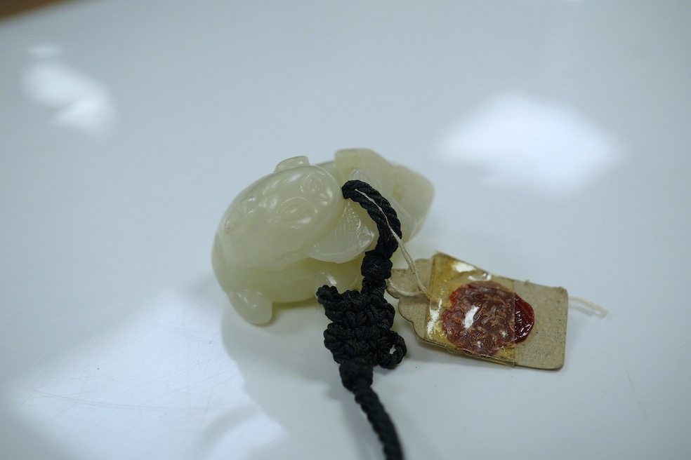 Two Chinese jade carvings, 18th/19th century including a pale jade example in the form of an animal with red wax seal, largest 4.2cm wide. Condition - good